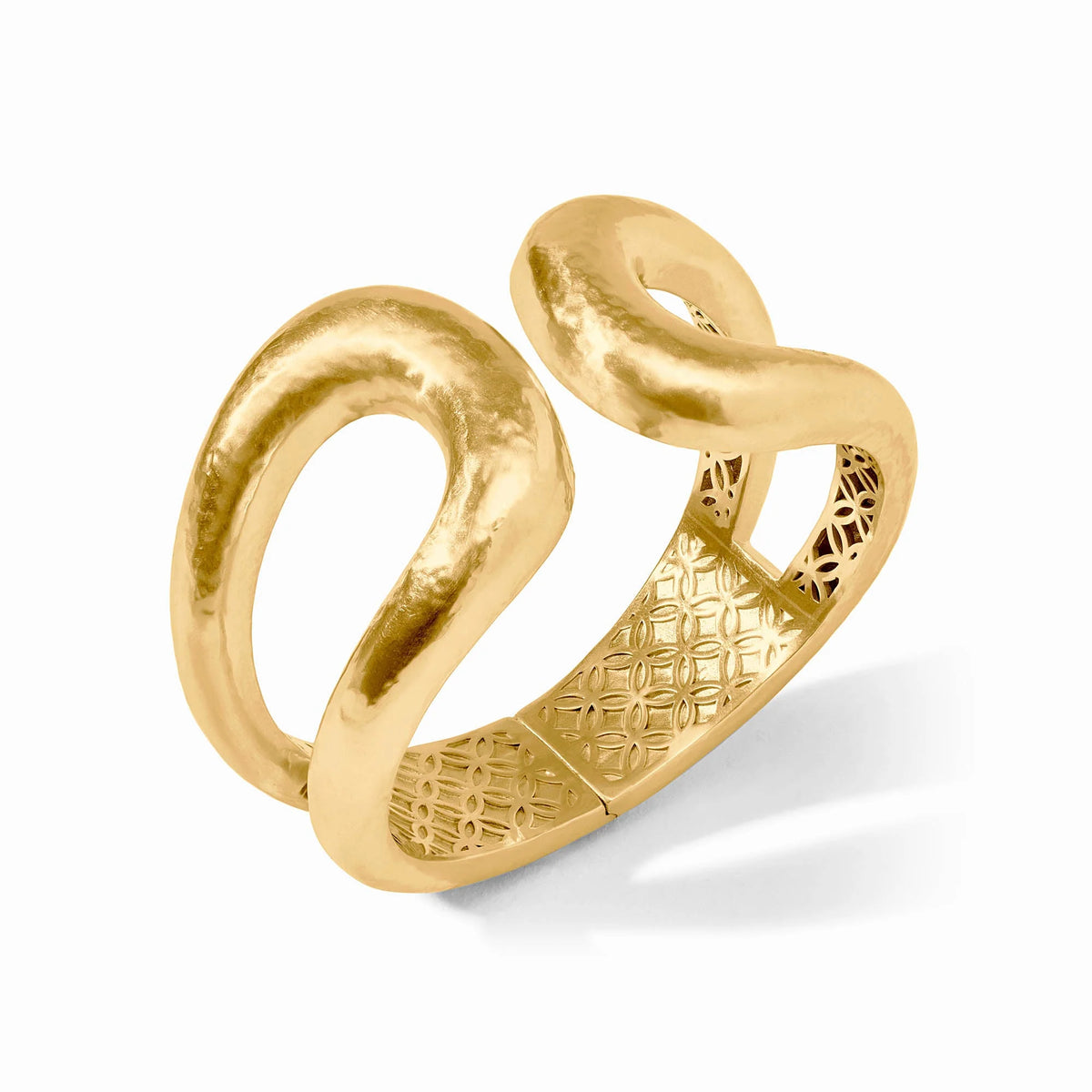 The Solara Cuff is a gold ring with a bold, wavy open design and textured inner band. Available in sizes 6, 7, and 8.