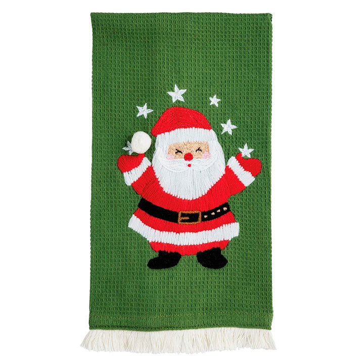 Green Christmas waffle knit hand towels with embroidered Santa, white stars, and fringe hem.