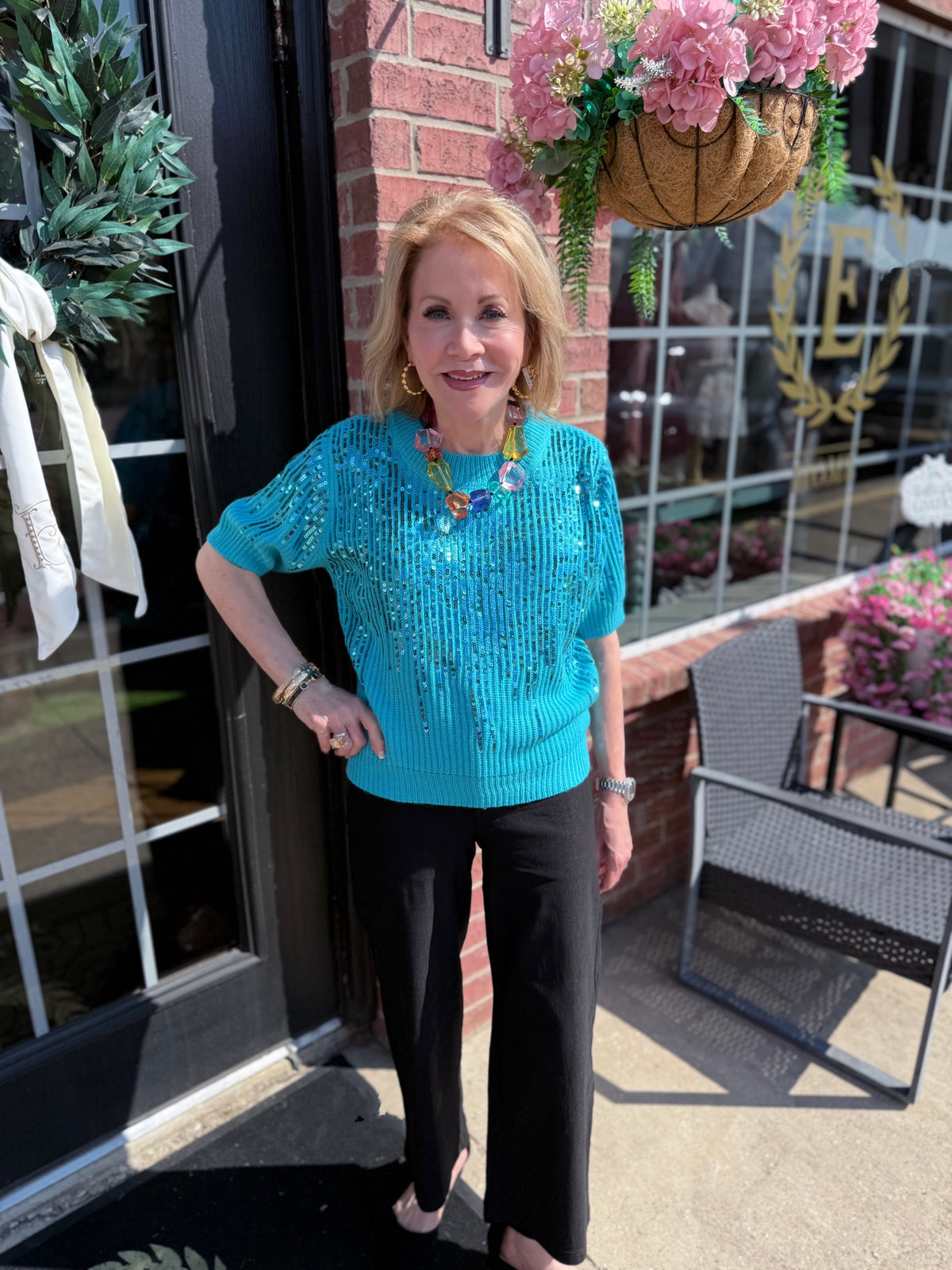 Rosalie Sequin Blouse: turquoise with floral sequin detailing. Available in sizes XS–XL.