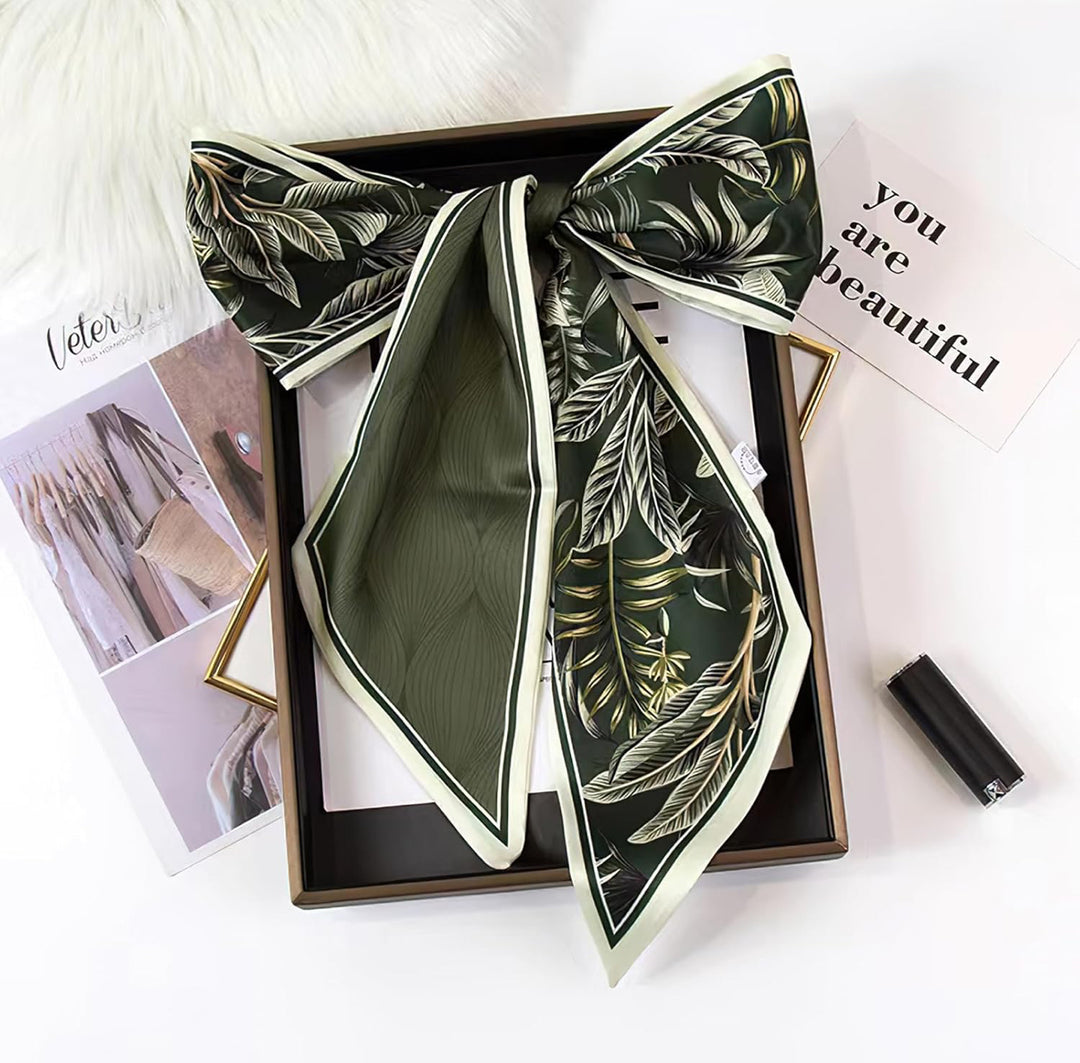 Green silk scarf with a leaf pattern, folded into a bow. Available sizes: S, M, L.