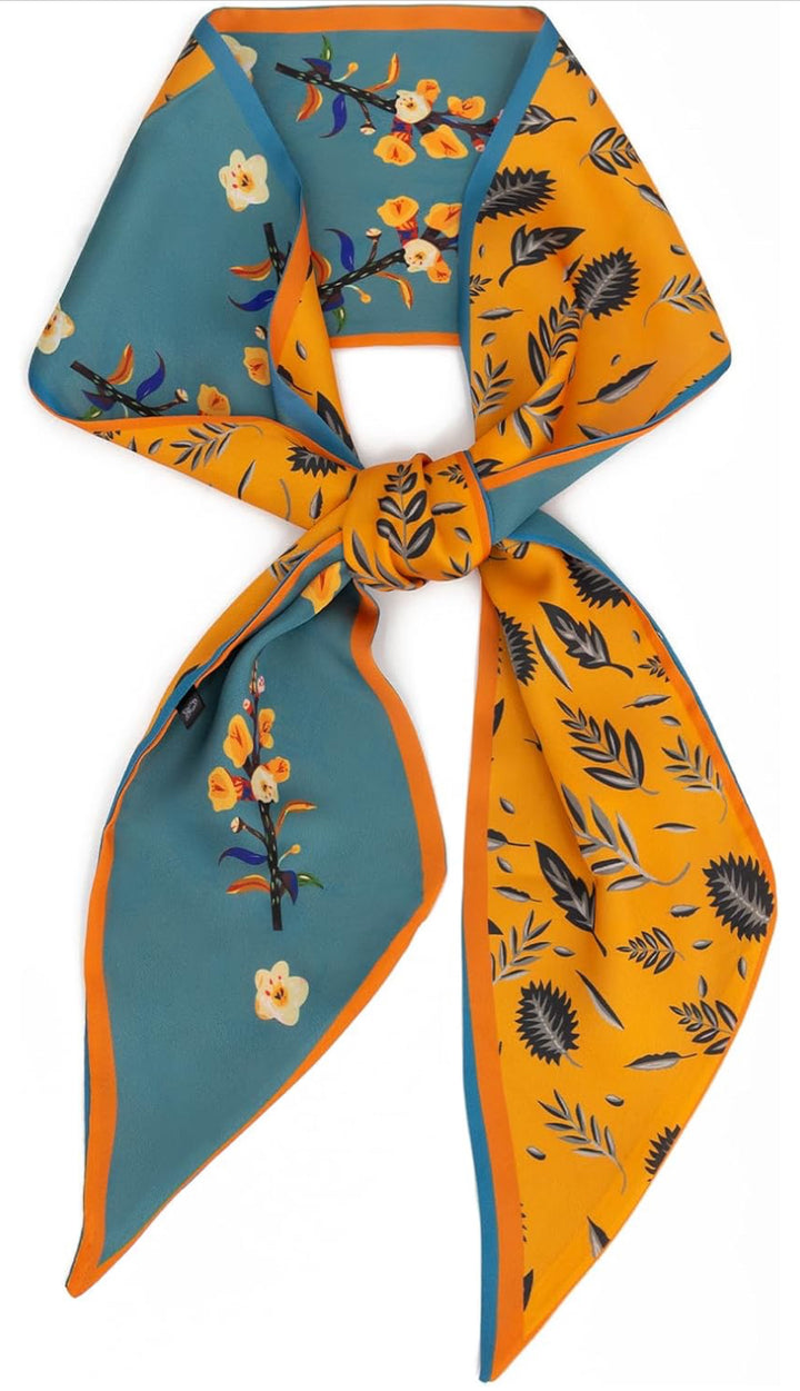 Silk scarf in turquoise and mustard with orange floral and bird patterns, black and white accents. Available in S, M, L.