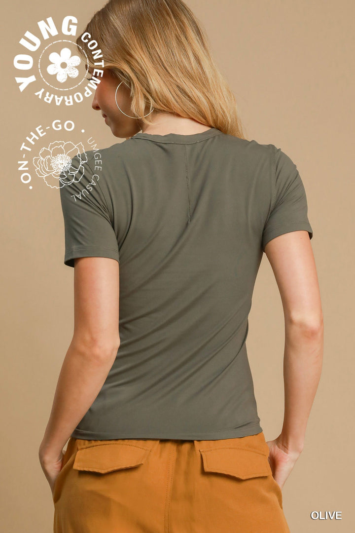 Olive green Second-Skin Crew Neck Tee shown. Available in sizes XS–XL. White text and floral graphics overlay the image.