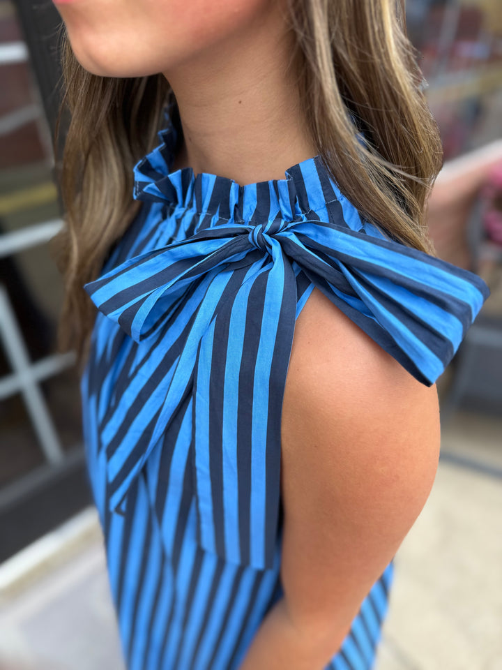 Navy Stripe Tie-Neck Midi Dress with sleeveless blue-black stripes, ruffled neckline, shoulder bow. Sizes: XS–XL.