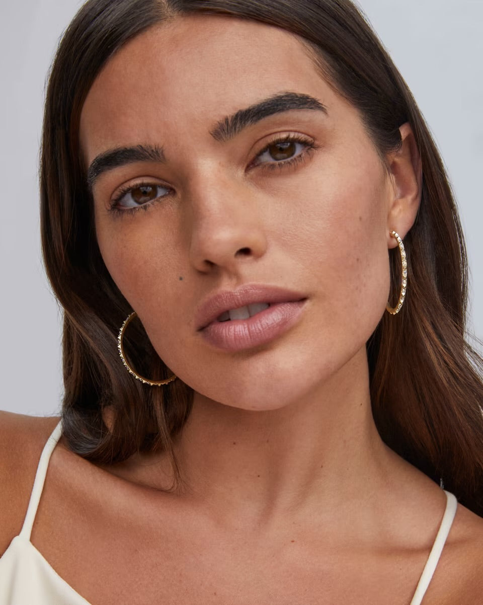 Kendra Scott Veronica Hoop Earrings in Iridescent Crystal, available in small and large sizes.
