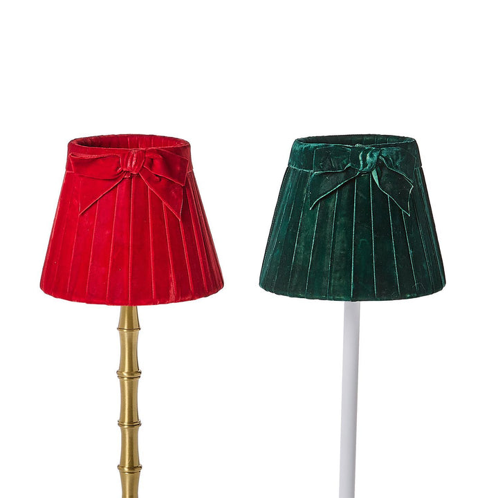 Two red and dark green pleated velvet bow lampshades.