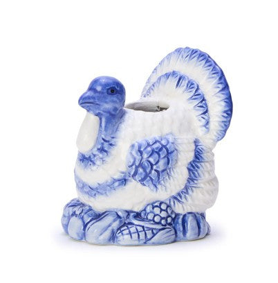 Blue and white hand-painted turkey ceramic candleholder with intricate feather details, blue accents, and a hollow opening for candles. Base features fruit and corn motifs. Available sizes: small (5″), medium (7″), large (9″).