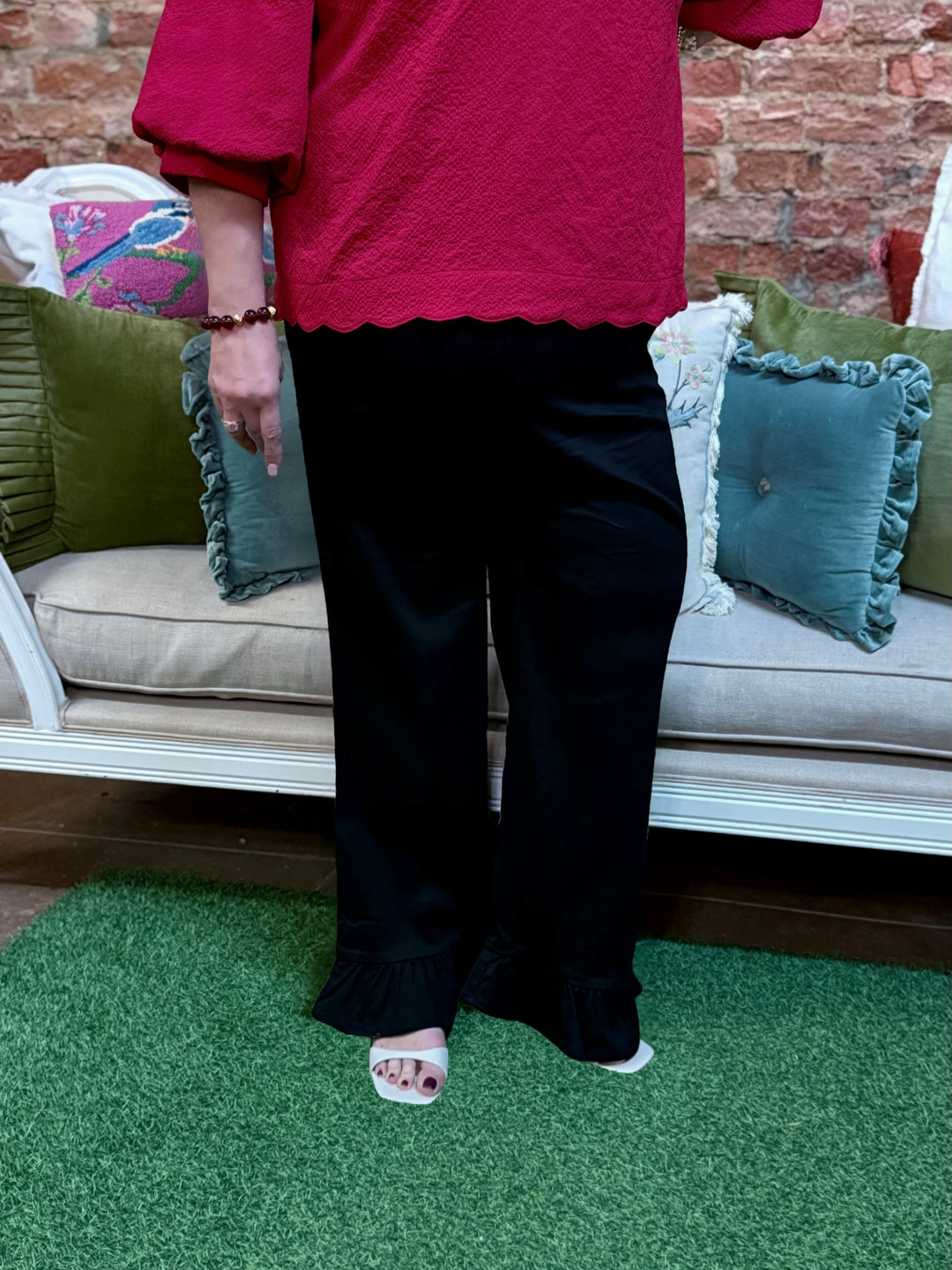 Black wide-leg ruffle pants with ruffle hem. Available in multiple sizes.