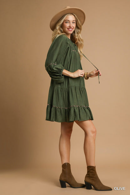 Juniper Tiered Long Sleeve Dress in olive, available in sizes XS-XL. Features tiered design and long sleeves.