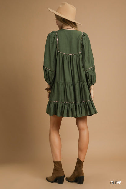 Juniper Tiered Long Sleeve Dress in olive green with ruffle details. Available in sizes XS–XL.