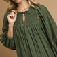 Juniper Tiered Long Sleeve Dress in olive with gathered yoke and tie neckline. Available in sizes XS-XL.