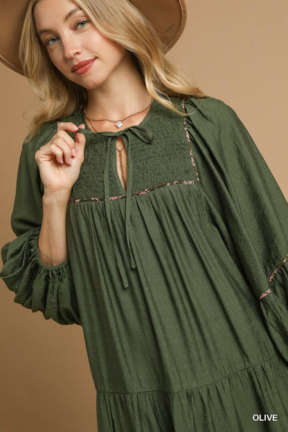 Juniper Tiered Long Sleeve Dress in olive with gathered yoke and tie neckline. Available in sizes XS-XL.