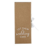 Brown two-piece cake serving set gift box with white ribbon bow and “LET THEM EAT wedding CAKE” text.