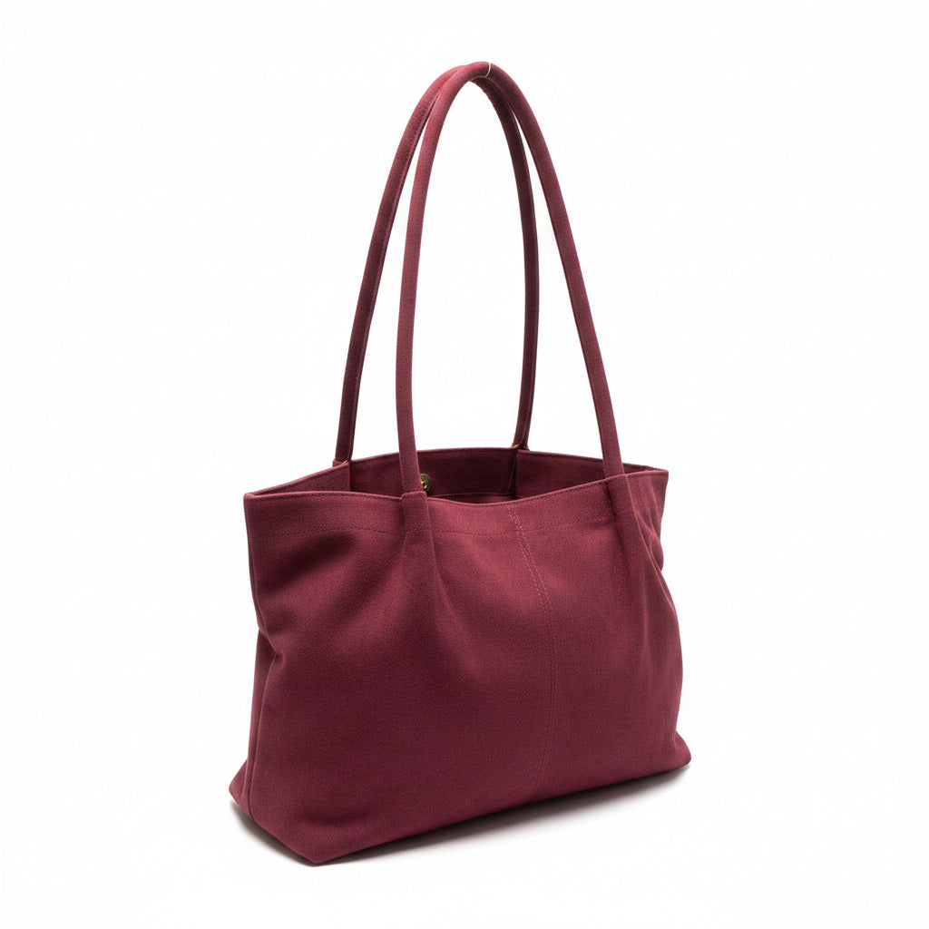 Maroon suede tote bag with two long handles, made of fabric. Available in small, medium, and large sizes.