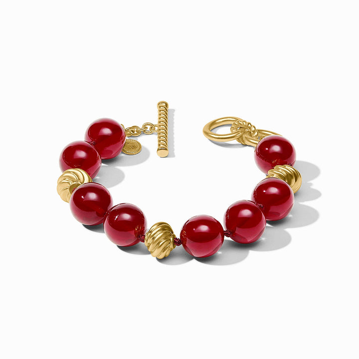 Ravello Cranberry toggle-clasp bracelet with alternating cranberry red beads and gold-toned ridged spheres.