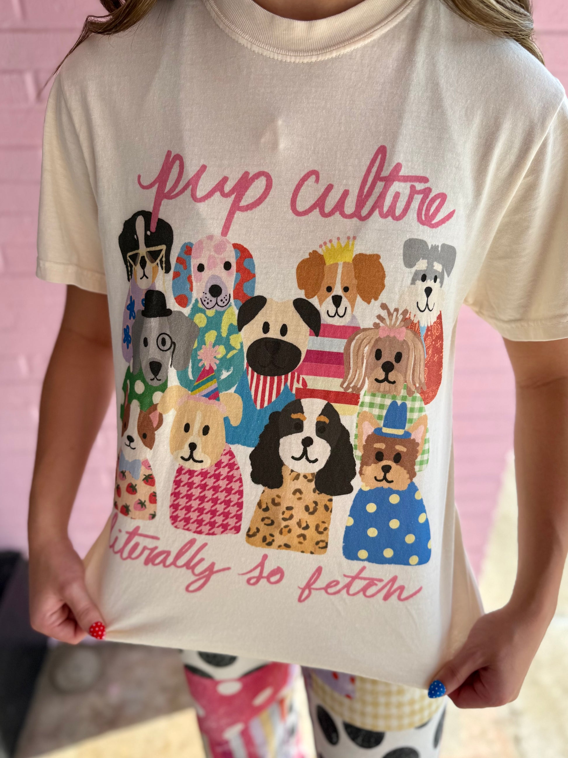 Cream Comfort Colors tee with illustrated pop culture dogs, “pup culture,” and “literally so fetch” in pink; sizes S-XXL.