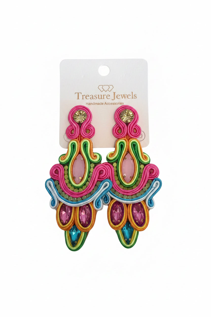 The Clara Neon Earrings are colorful drop earrings with pink, green, blue, and yellow embroidery and gemstones. Available sizes are not specified. Displayed on a "Treasure Jewels Handmade Accessories" card.