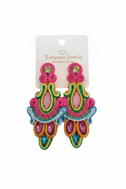 The Clara Neon Earrings are colorful drop earrings with pink, green, blue, and yellow embroidery and gemstones. Available sizes are not specified. Displayed on a "Treasure Jewels Handmade Accessories" card.