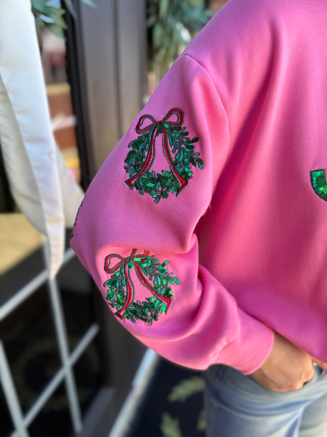 Pink Sarah Joy Wreath sweatshirt with sequined sleeves. Sizes available.