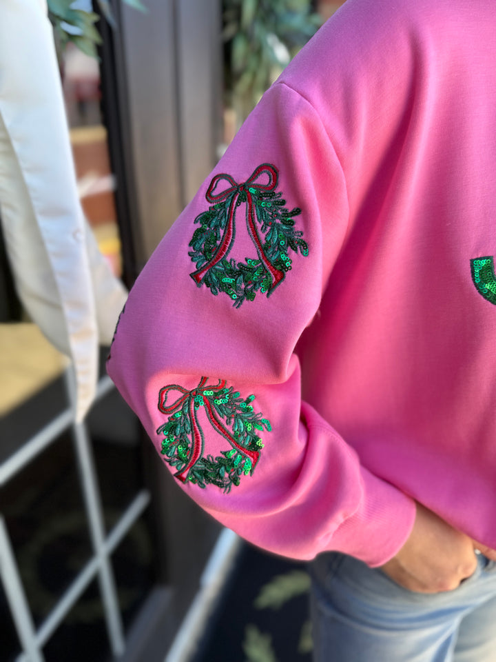 Pink Sarah Joy Wreath sweatshirt with sequined sleeves. Sizes available.