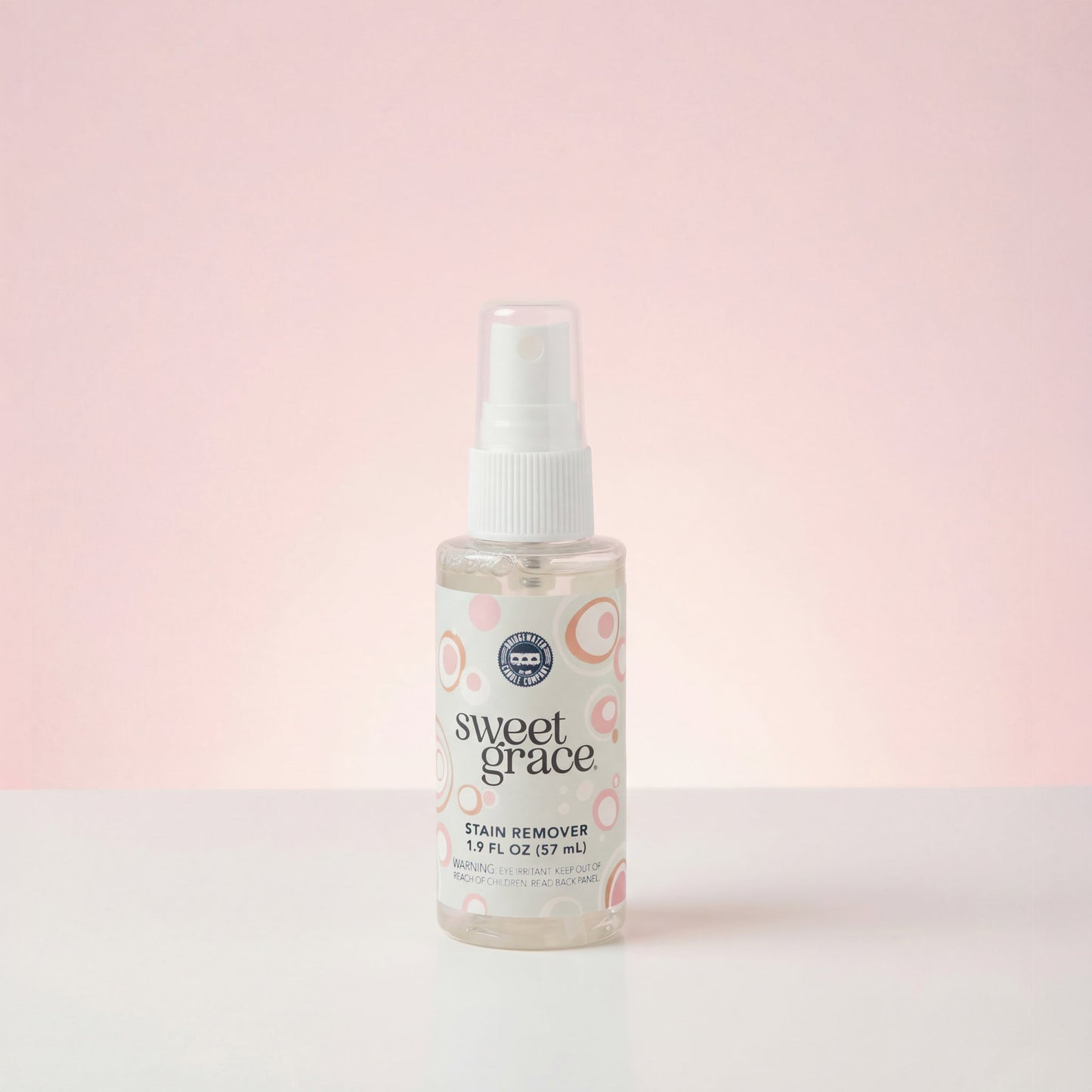 The Sweet Grace Stain Remover spray, small bottle with pink and beige circles on label. Available in several sizes.