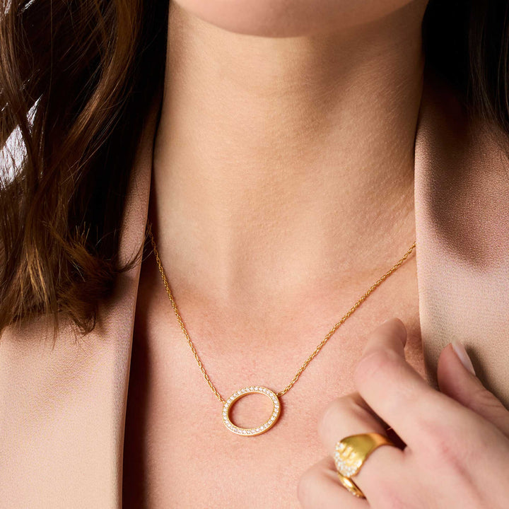 Stardust Delicate Necklace with a thin 24K gold plate chain and adjustable circular CZ stone pendant.
