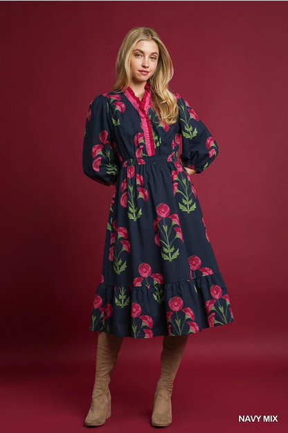 Louise Floral Midi Dress: navy with pink and green floral pattern, long puffed sleeves, ruffle details. Sizes XS-XL.