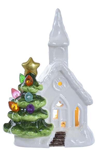 Illuminated white ceramic LED church with mini green tree, gold star topper, and multi-colored lights.
