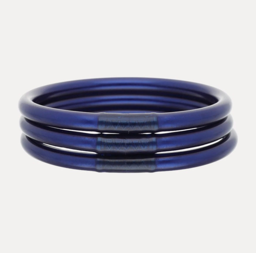 Set of three metallic blue Midnight All Weather Bangles with textured darker blue accents, waterproof and handcrafted in Thailand. Available in small, medium, and large sizes.