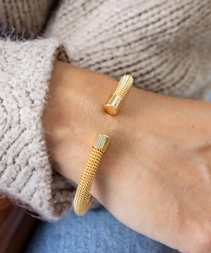 Cuff Paris gold mesh hypoallergenic bracelet with polished cylindrical ends; available in S, M, and L.