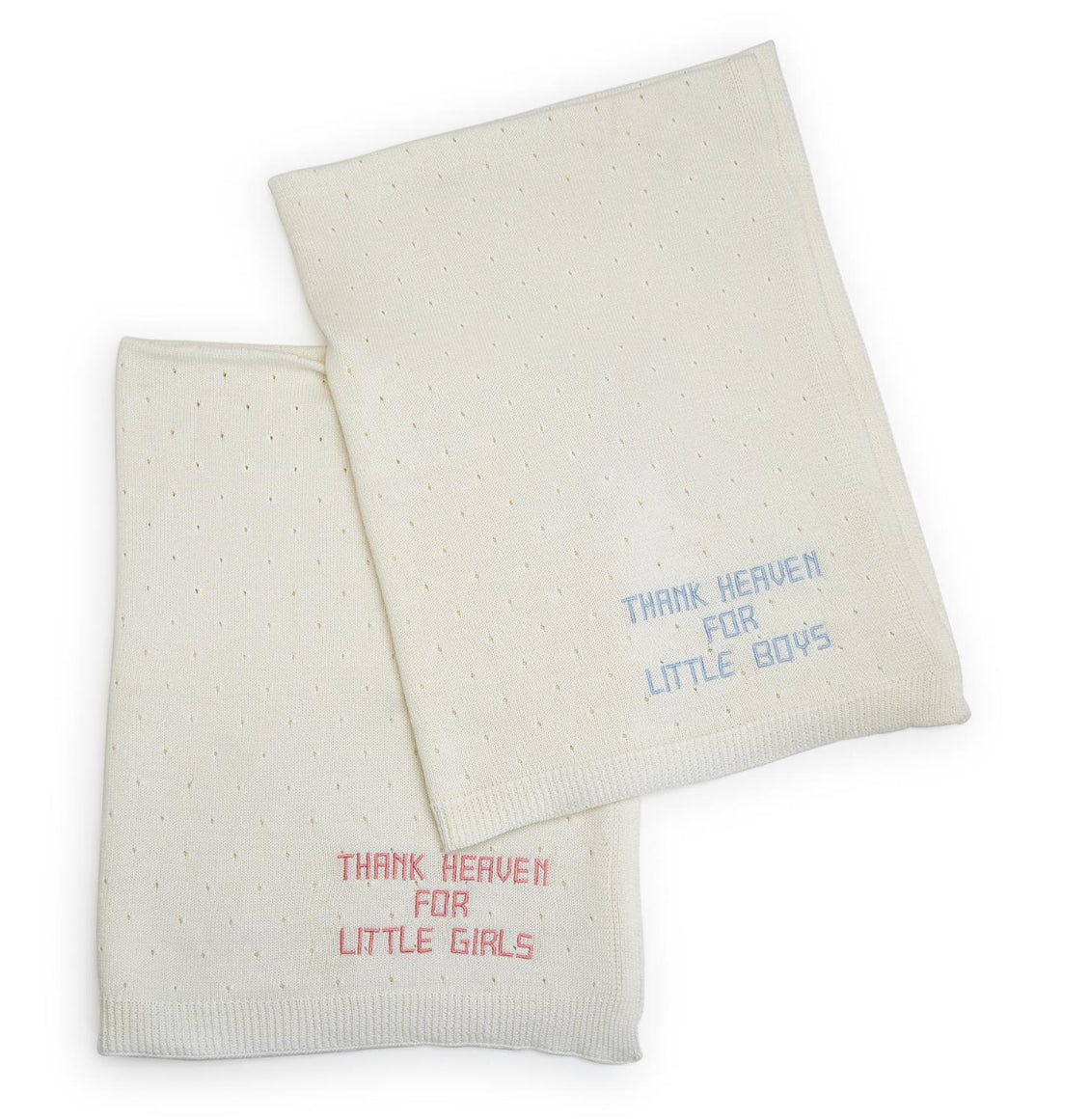 Two Thank Heaven Embroidered Knit Blankets: Soft white cotton with tiny dotted patterns. One reads "THANK HEAVEN FOR LITTLE BOYS" in blue and the other "THANK HEAVEN FOR LITTLE GIRLS" in pink. Available size: 30" x 40".