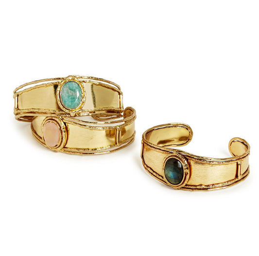 Three Statement Stone Cuff bracelets with a polished finish and textured gold accents. Featuring labradorite, pink quartz, and dark blue stone gemstones. Available sizes: S, M, L.