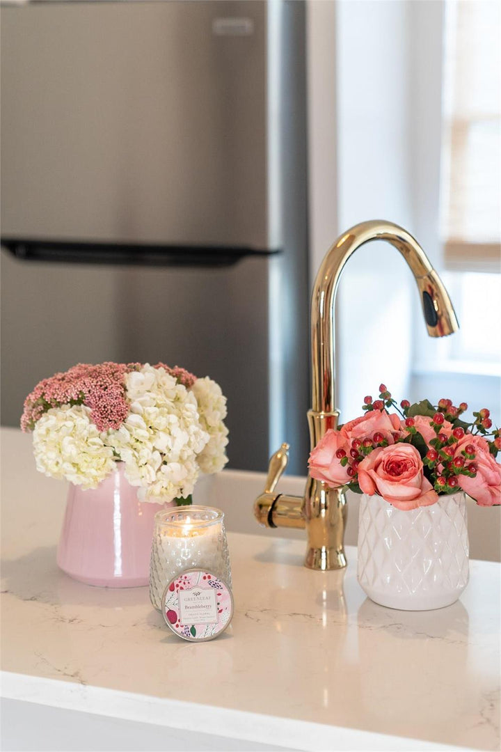 Brambleberry Signature Candle in a clear glass jar with a floral label.