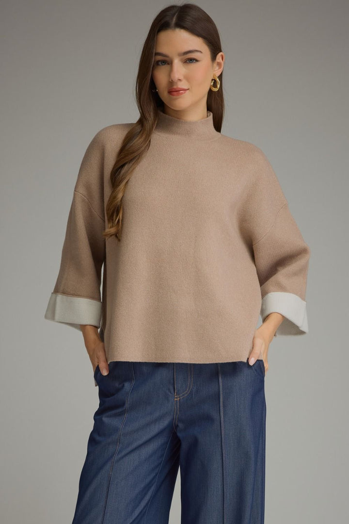 Tan mock neck sweater with cream-colored three-quarter sleeves and cuffs in a soft knit. Available in all sizes.
