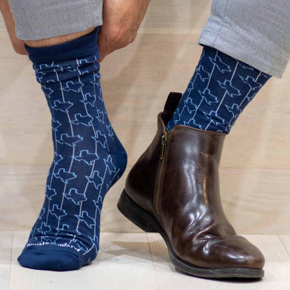 Blue Men’s Sock with white abstract design, shown on foot. Available in sizes S–XL.