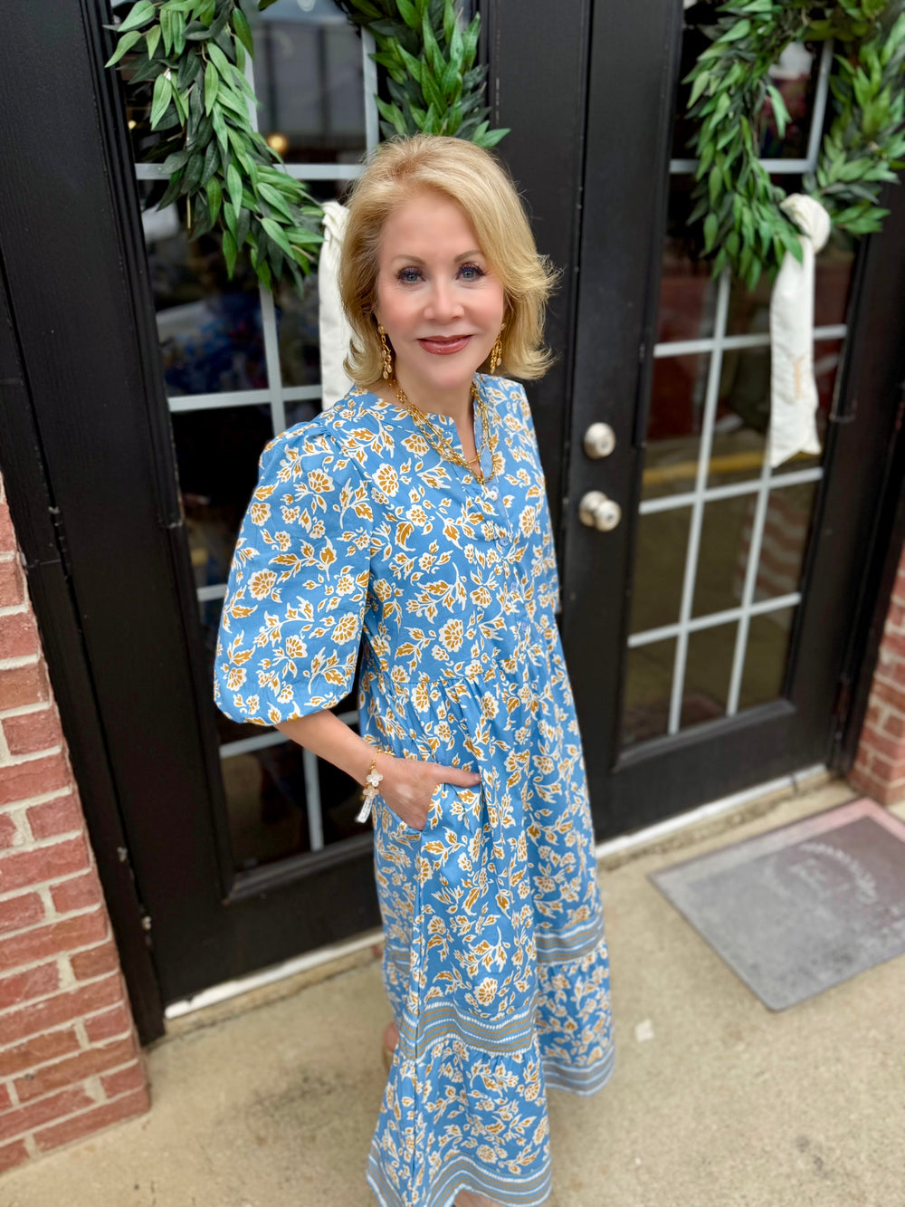Blue and yellow floral Riley Ivy Script Gold Dress with 3/4 sleeves. Available in sizes XS–XL.