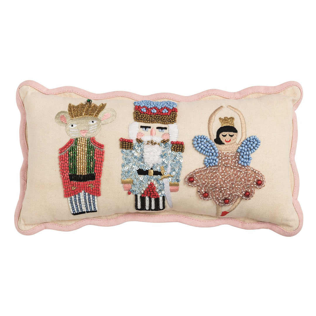 Nutcracker Beaded Pillow: a rectangular, scalloped-edge cushion featuring beaded and embroidered illustrations of a mouse king, a nutcracker, and a ballerina.
