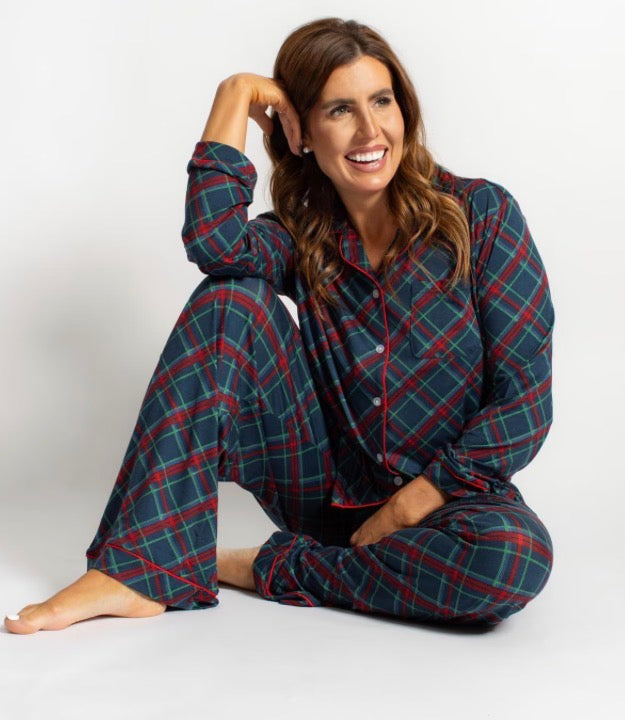 Women’s Layton Plaid Sleep Pants and matching long-sleeve button-up pajama shirt in navy, red, and green plaid with red piping. Available in various sizes.