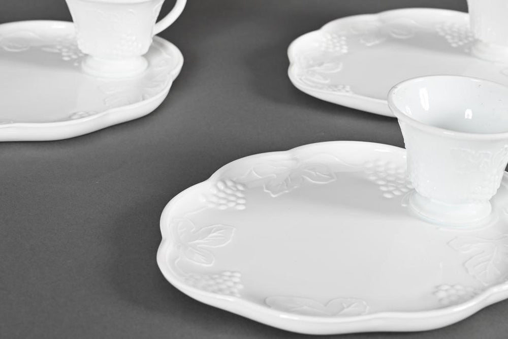 Set of three white milk glass snack plates and cups with embossed grapevine pattern. Sizes available: small, medium, large.