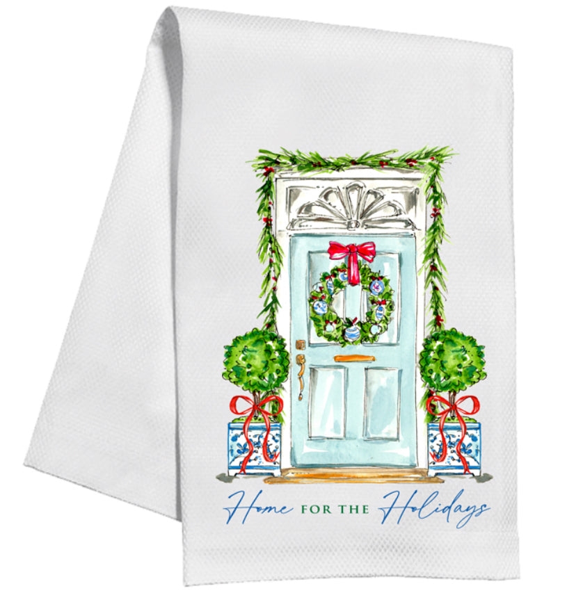 Product: Holiday Handpainted Kitchen Towels  
Description: White towel with a festive front door illustration (wreath, red bow, topiaries, garland) and "Home for the Holidays" text.   
Material: 100% cotton  
Care: Machine washable  
Sizes available: One size