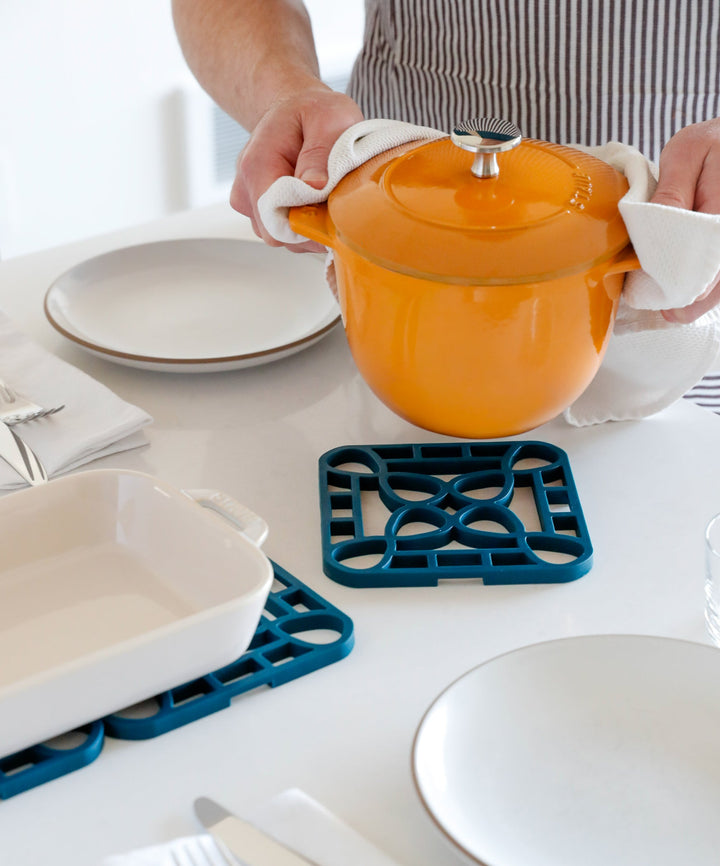 Blue Interlocking Trivet in use. Available in small, medium, and large sizes.