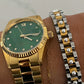 Gold wristwatch with thin gold watchband, green face, Roman numeral XII, and diamond hour markers. Sizes available: Small, Medium, Large.
