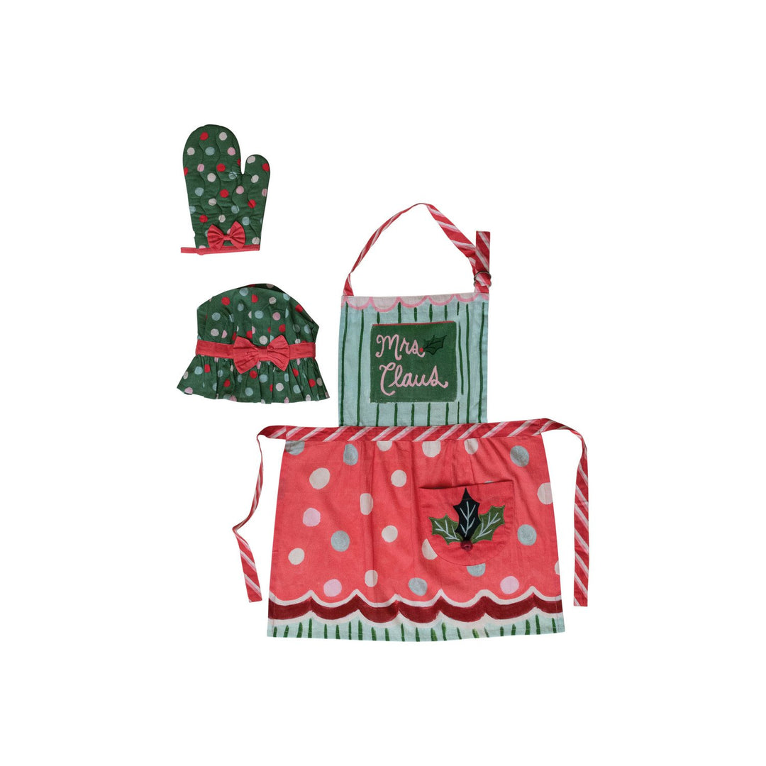 Mrs Claus child apron with holly embroidery, pom poms, candy cane-striped ties, and matching chef hat and oven mitt. Available in child sizes.