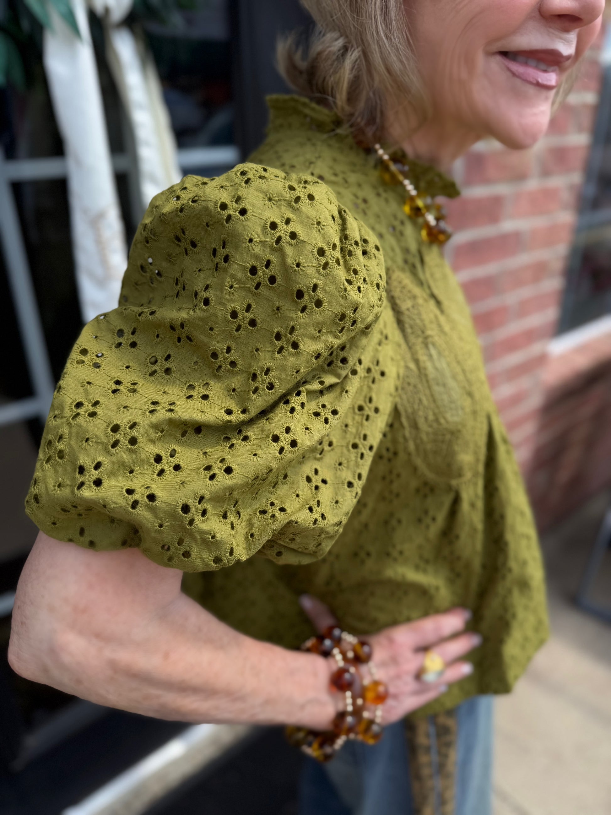 Green Ruffled Eyelet Puff Sleeve Top with delicate eyelet details, available in sizes XS-XL.