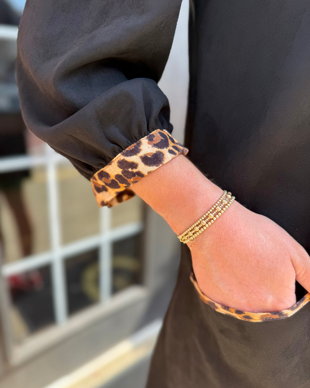 Leopard Contrast Dress: black faux suede with leopard trim on 3/4 sleeves and pocket. Available in sizes S-XL.
