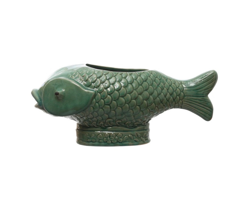 Turquoise Fish Planter: ceramic vase shaped like a fish with detailed scales and fins, upright on an oval base with embossed flowers. Opening along fish’s back for planting. Available in small, medium, and large sizes.