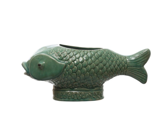 Turquoise Fish Planter: ceramic vase shaped like a fish with detailed scales and fins, upright on an oval base with embossed flowers. Opening along fish’s back for planting. Available in small, medium, and large sizes.