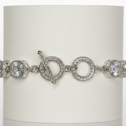 Jason Silver Clear Crystal Tennis Bracelet with round white gemstones, toggle clasp, and intricate detailing around stones and clasp. Available in multiple sizes.