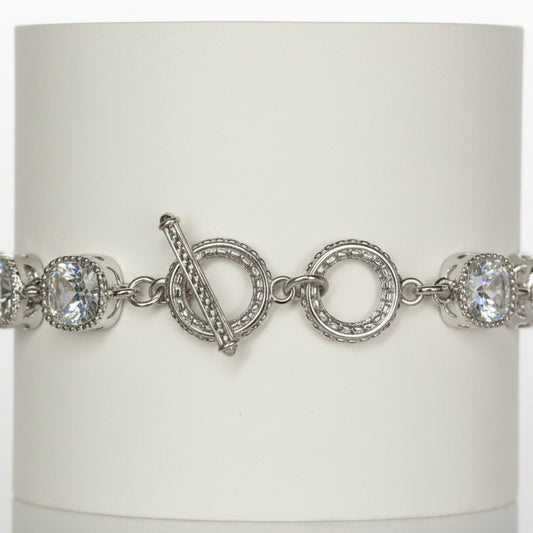 Jason Silver Clear Crystal Tennis Bracelet with round white gemstones, toggle clasp, and intricate detailing around stones and clasp. Available in multiple sizes.