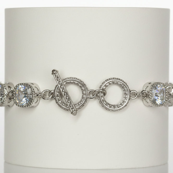 Jason Silver Clear Crystal Tennis Bracelet with round white gemstones, toggle clasp, and intricate detailing around stones and clasp. Available in multiple sizes.