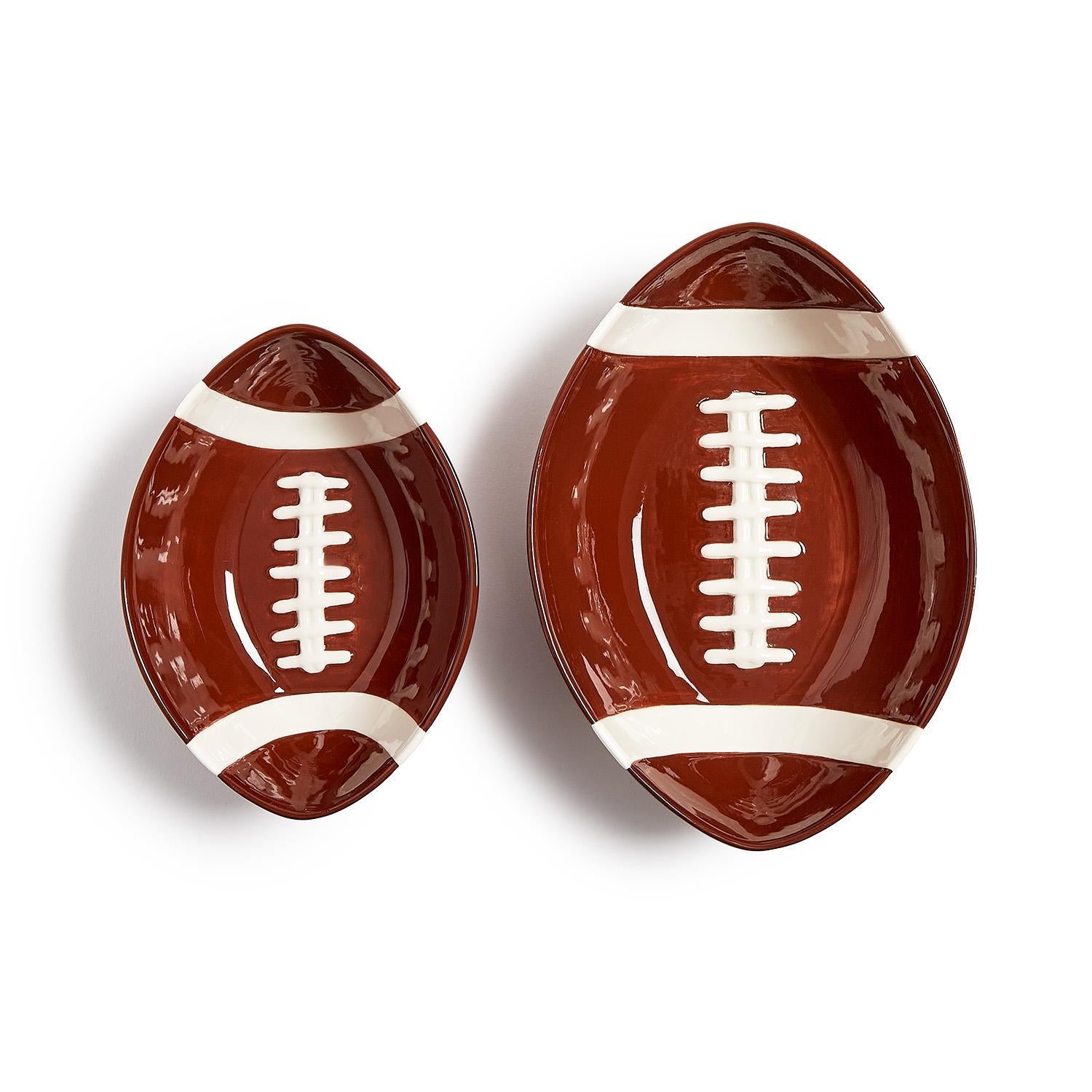 Two oval, football-themed tidbit bowls with white laces and stripes on a brown background; available in two sizes, one larger and one smaller.